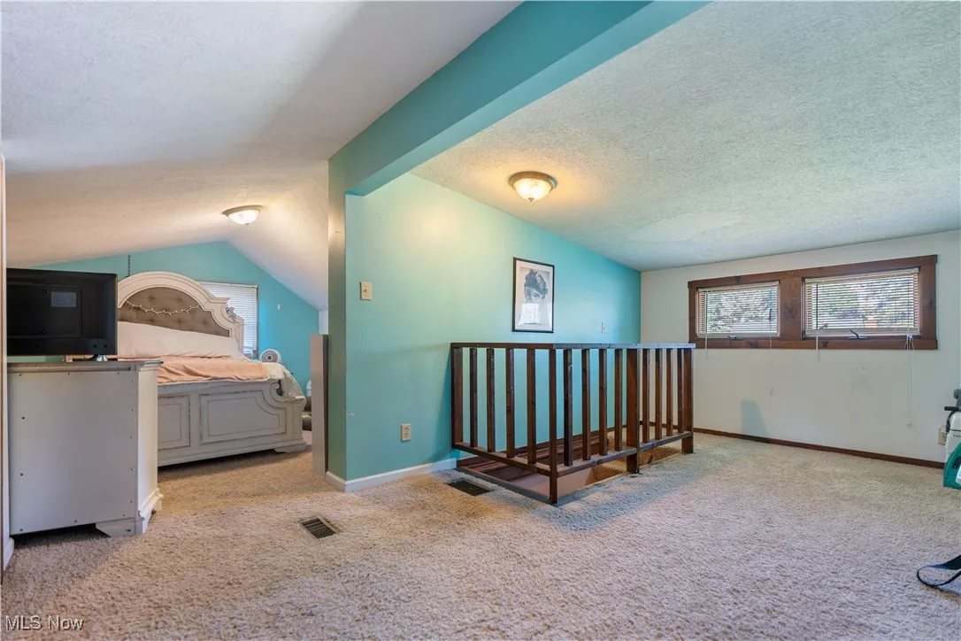 23x10 Carpeted master bedroom featuring lofted ceiling on the second floor.