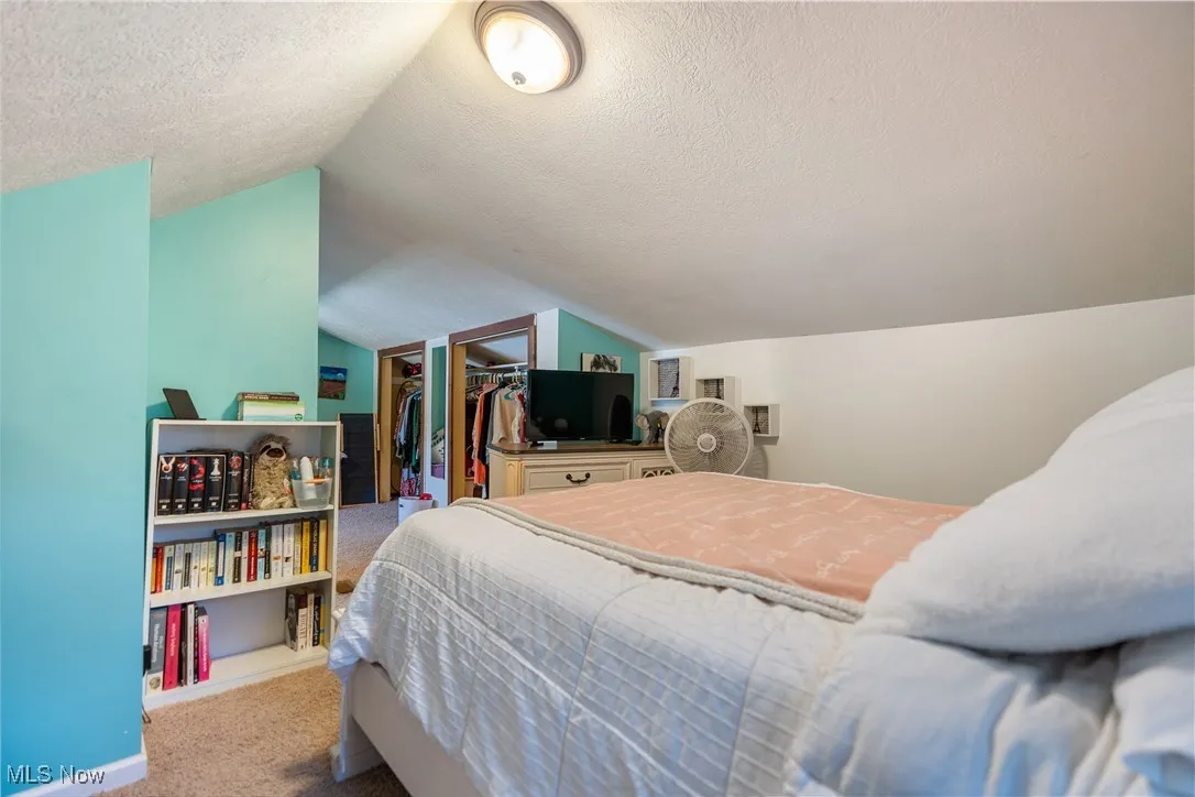 23x10 Carpeted master bedroom featuring lofted ceiling on the second floor.
