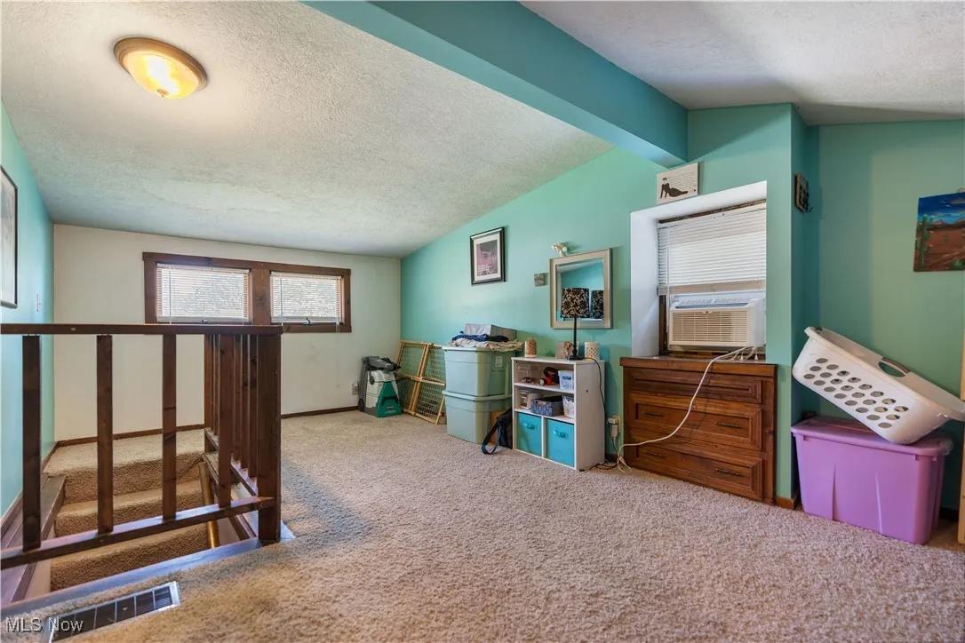 23x10 Carpeted master bedroom featuring lofted ceiling on the second floor.