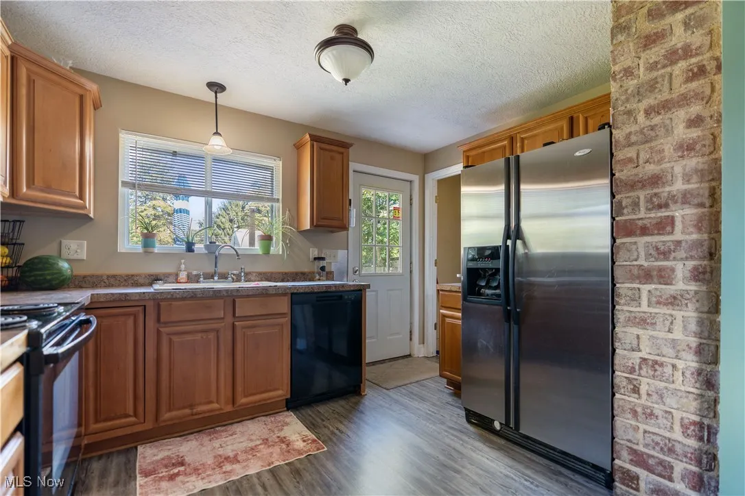 The kitchen has natural lighting from the window and door.