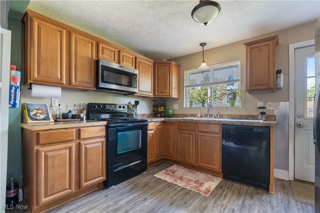Kitchen with over-sink window looking out to the back yard.