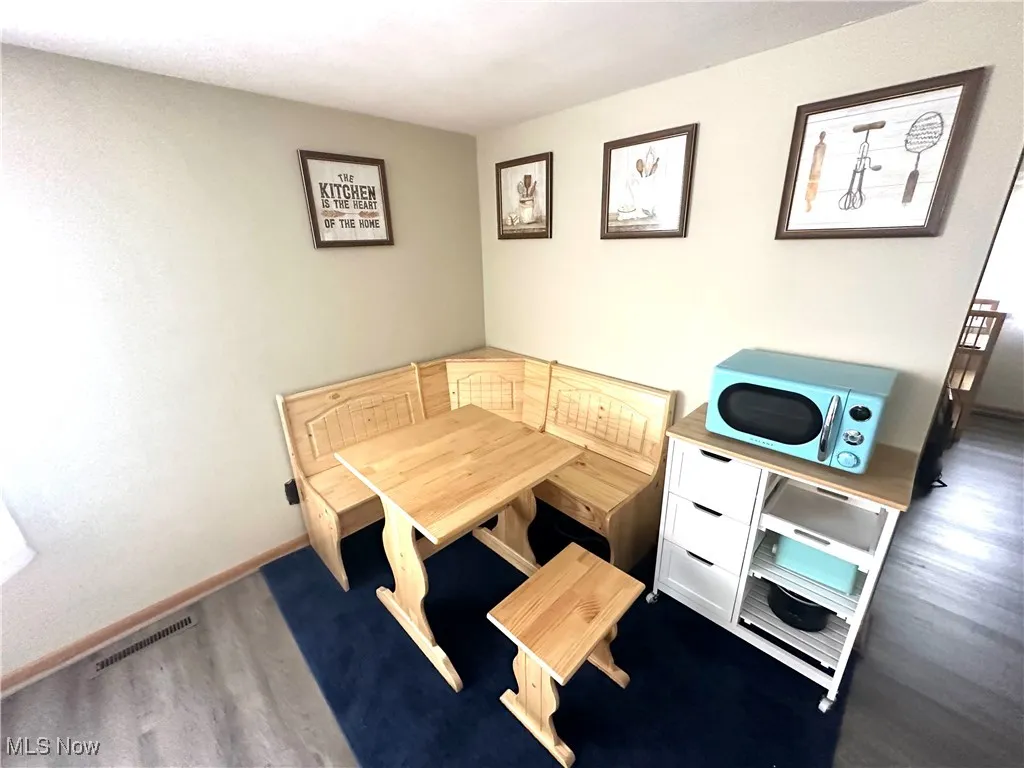 Dining room featuring wood finished floors and baseboards