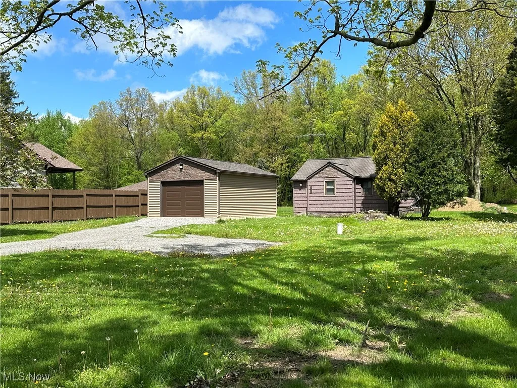 View of yard with an outdoor structure and a garage