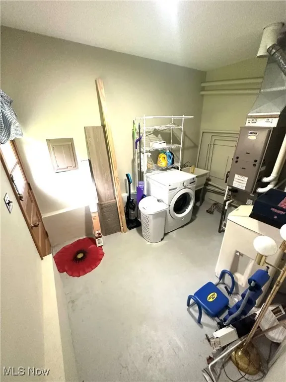 Washroom featuring independent washer and dryer, electric panel, and heating unit