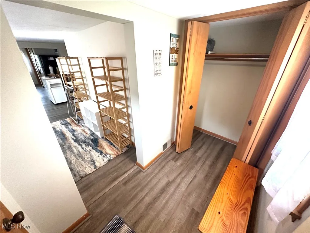 Hall with wood finished floors and baseboards