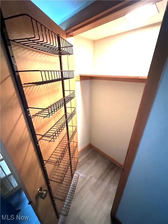 Stairway featuring wood finished floors and baseboards