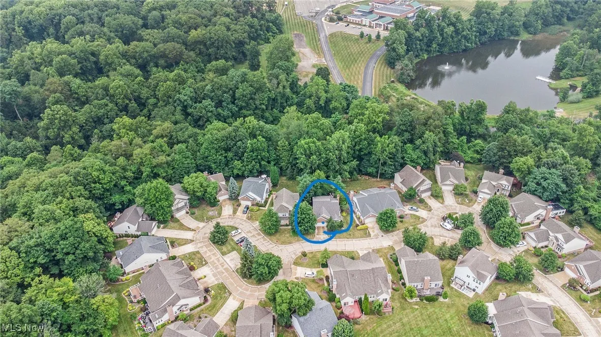 Aerial perspective of suburban area featuring a large body of water