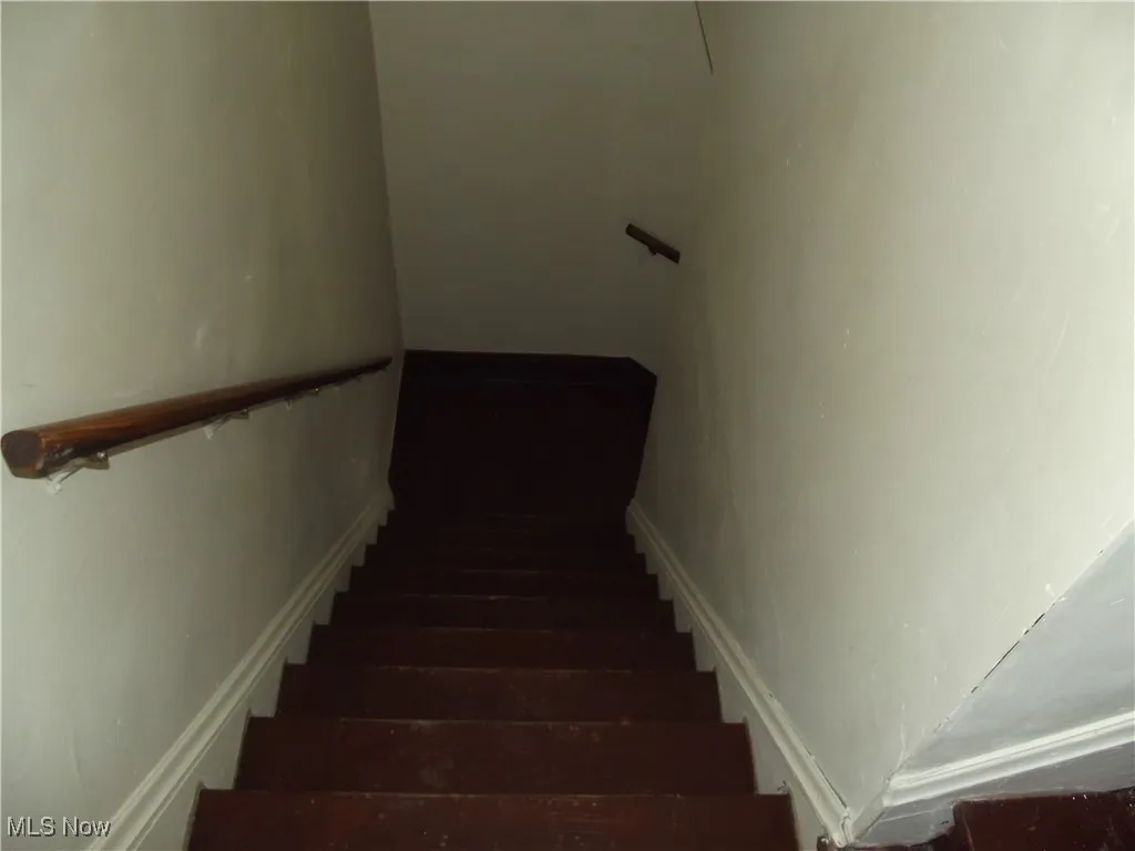 Stairway with dark hardwood / wood-style flooring