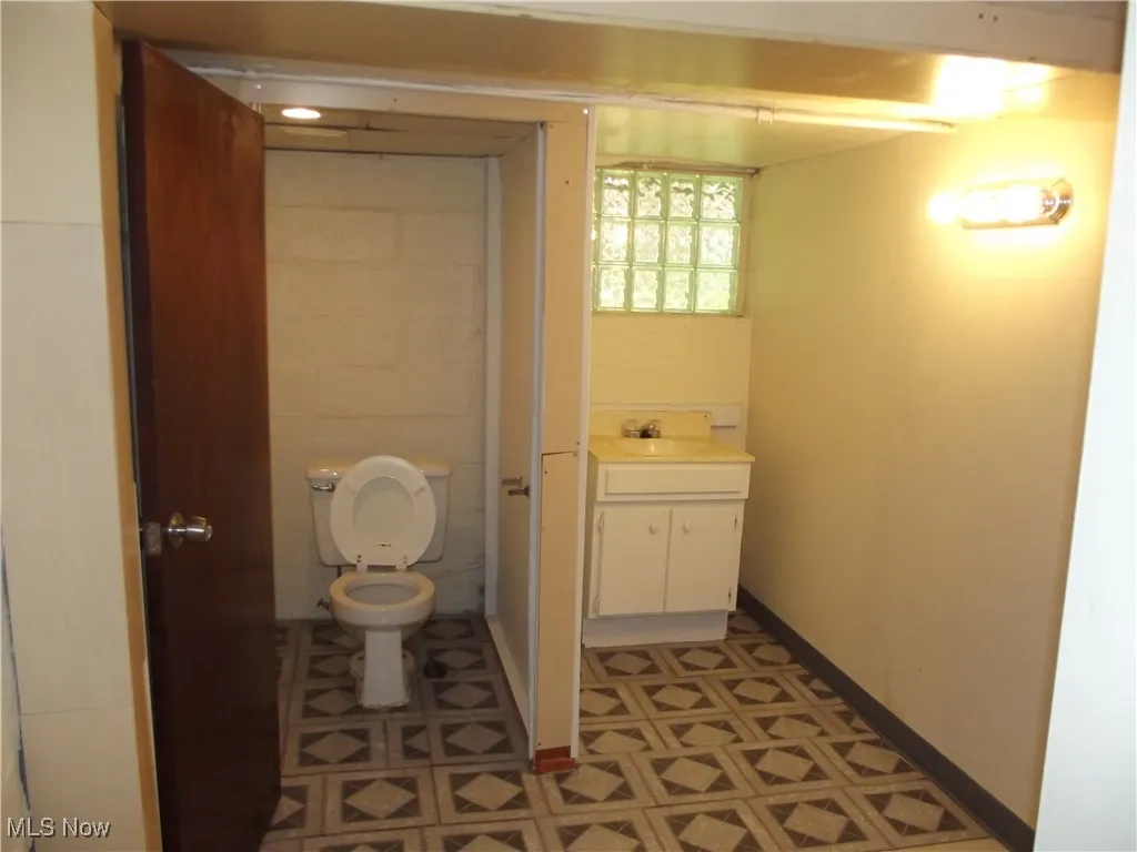 Bathroom with tile flooring, toilet, and vanity