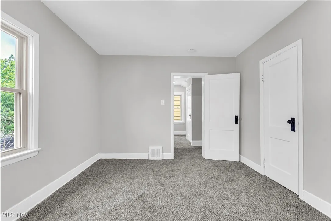 Unfurnished bedroom featuring carpet floors and baseboards