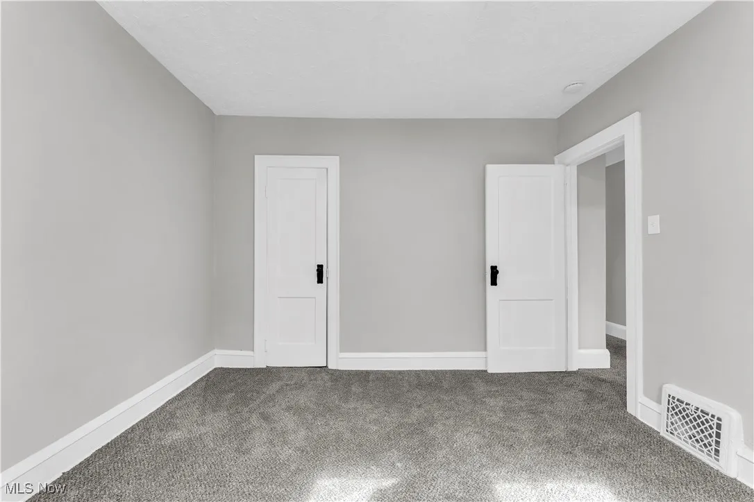 Unfurnished bedroom with carpet and baseboards