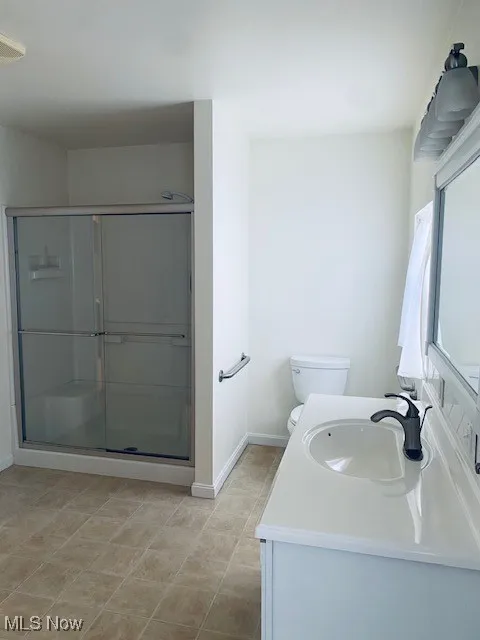 Full bathroom with vanity and a stall shower