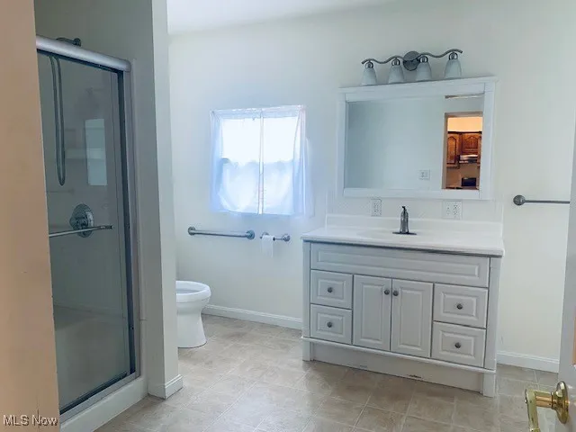 Full bath with vanity and a shower stall