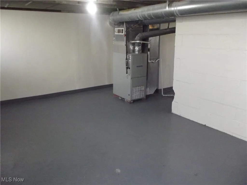 Basement featuring heating utilities