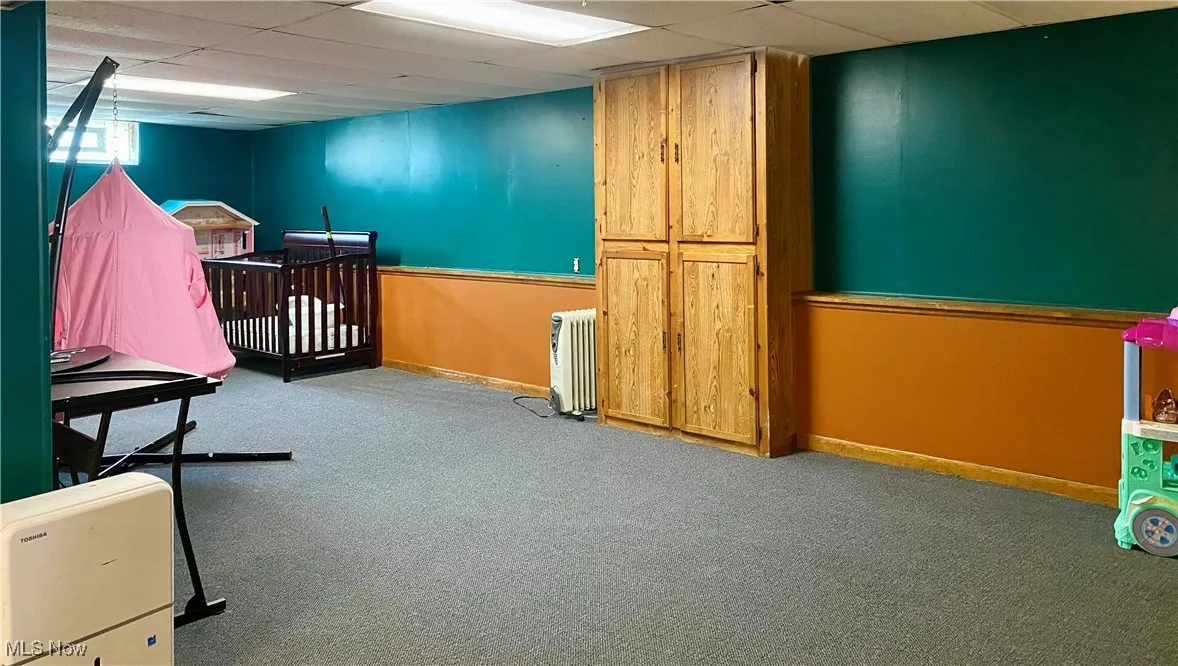 Bedroom featuring carpet and a drop ceiling