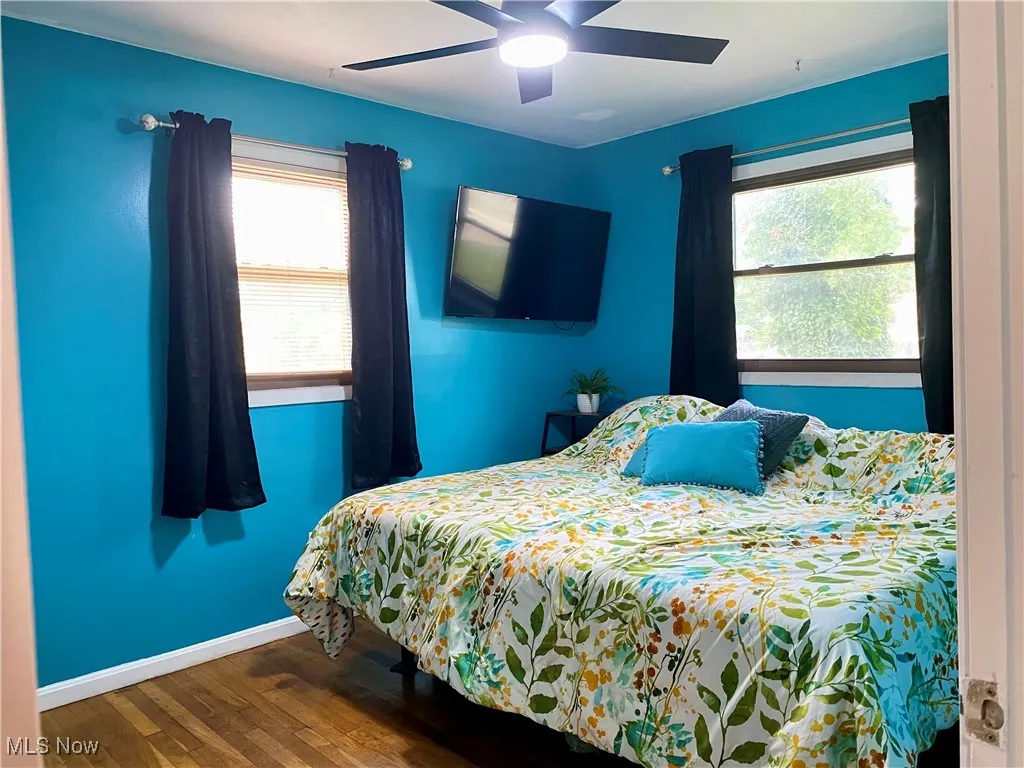 Bedroom featuring wood finished floors and ceiling fan