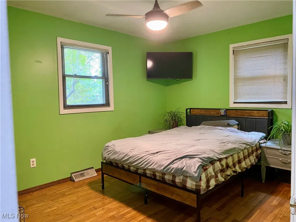 Bedroom with wood finished floors and a ceiling fan