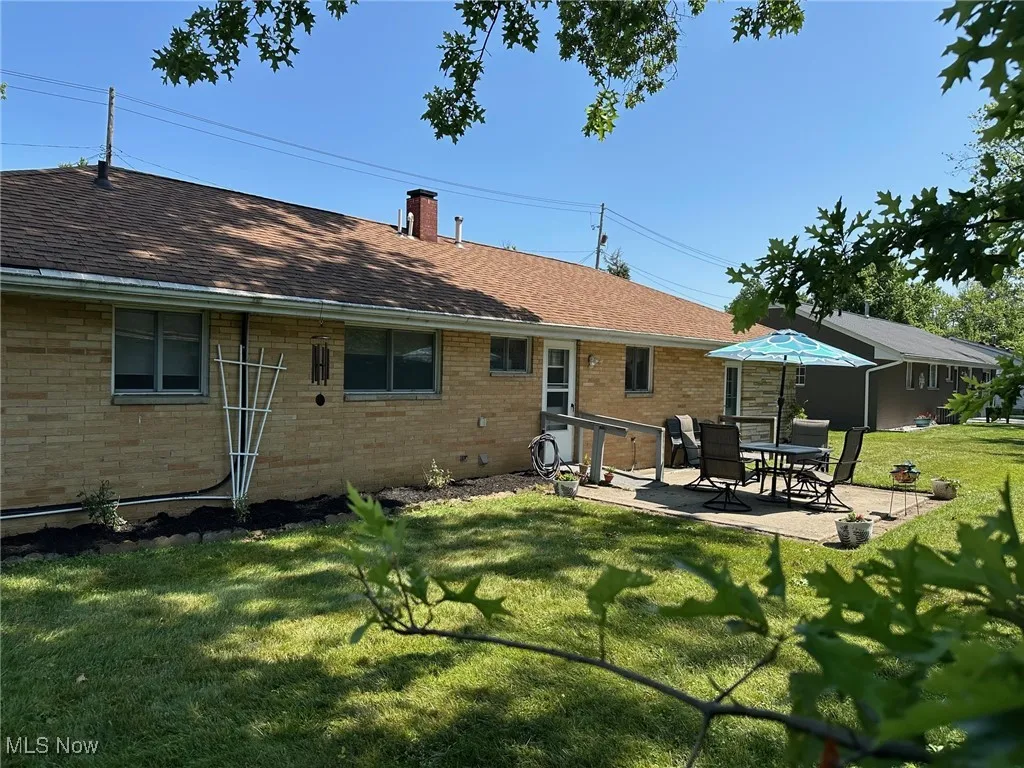 Tree shaded back yard with patio