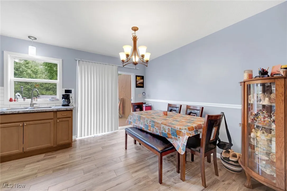 Dining space with a chandelier and light wood-type flooring