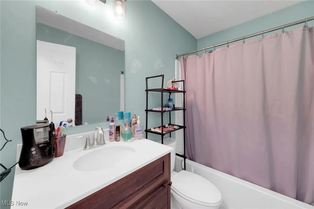 Bathroom with vanity and shower / bath combo