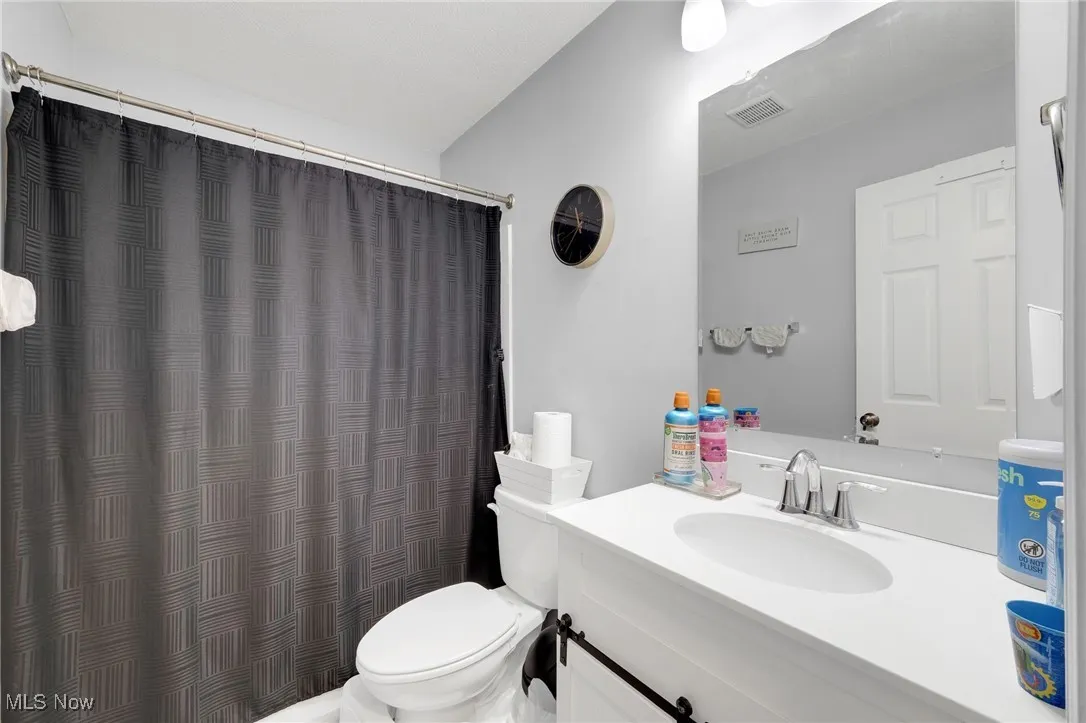 Full bath featuring vanity and a shower with shower curtain
