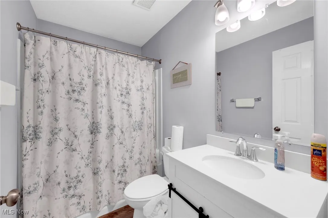 Bathroom featuring vanity and curtained shower