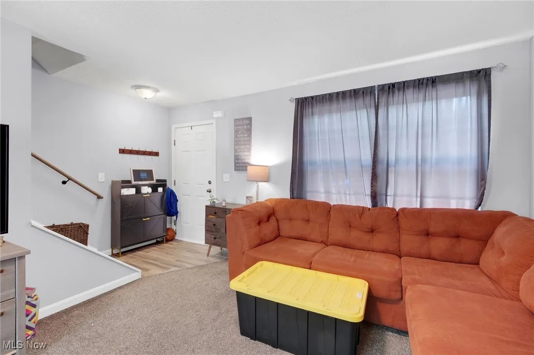 Living area with carpet flooring and stairs