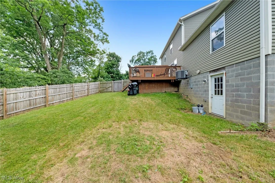 Fenced backyard with a deck