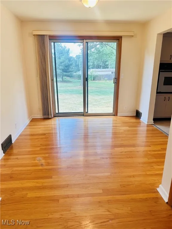 Empty room featuring healthy amount of natural light and light wood-style flooring