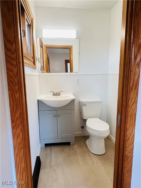 Bathroom with vanity and wainscoting