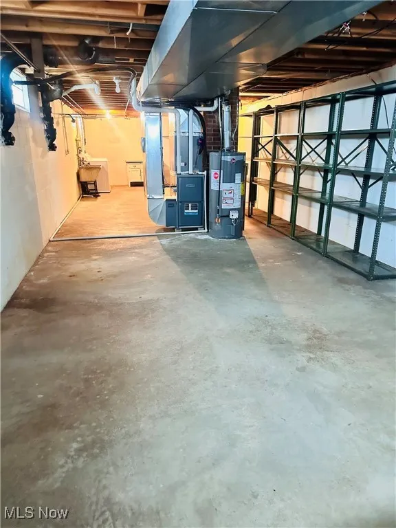 Unfinished below grade area with gas water heater and heating unit