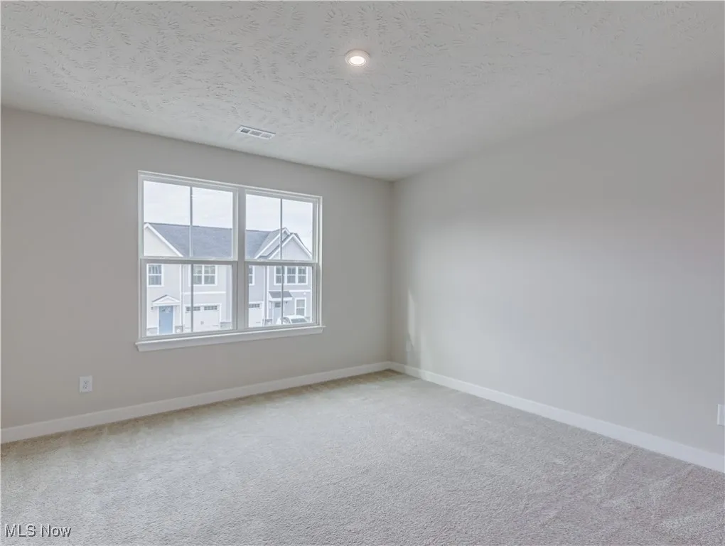 Second floor bedroom with carpet flooring