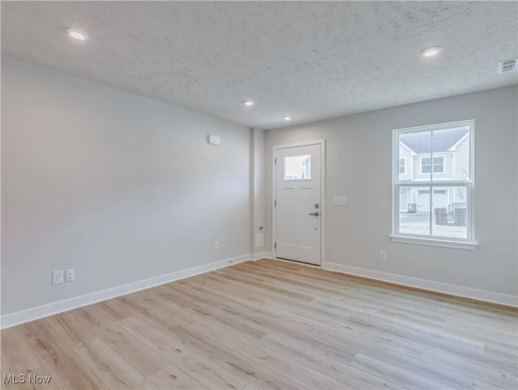 Great room with front door and LVT flooring