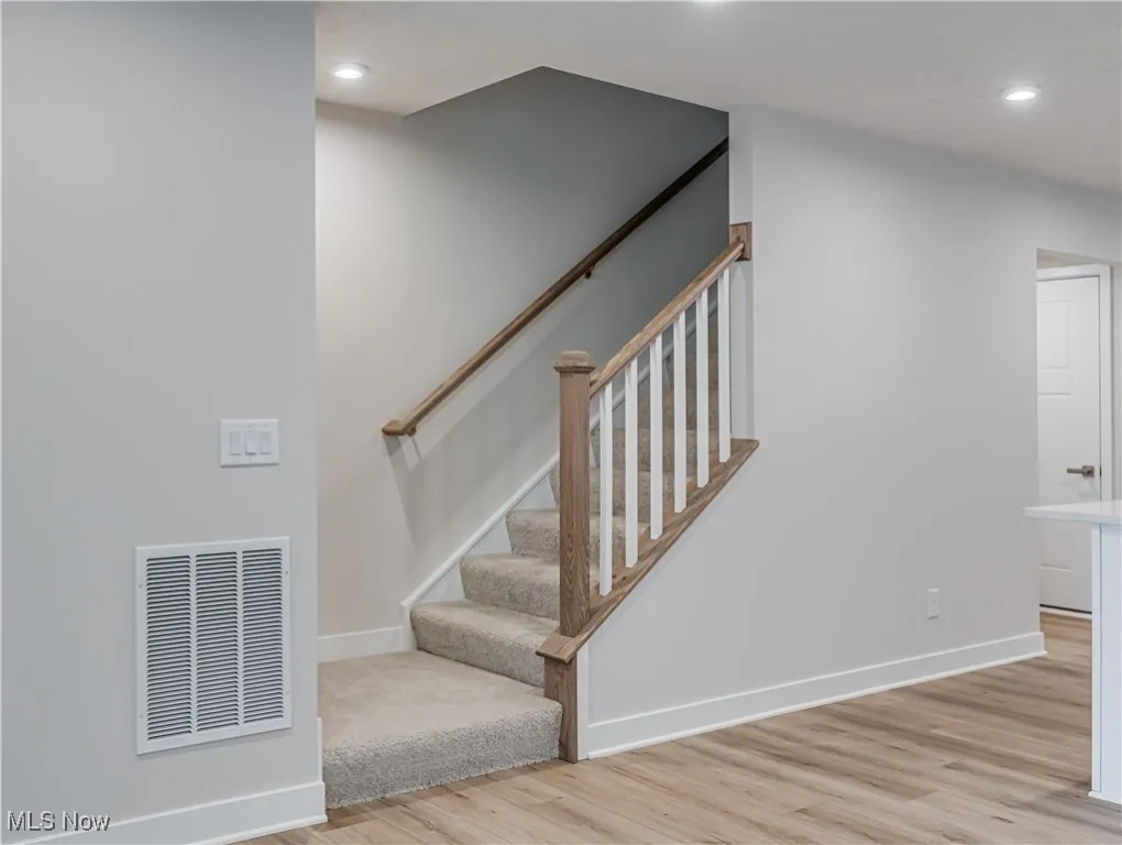 Carpeted stairway to second floor