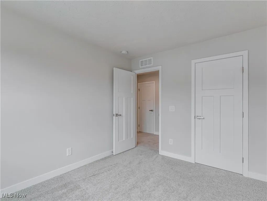 Another view of the second floor bedroom with a closet