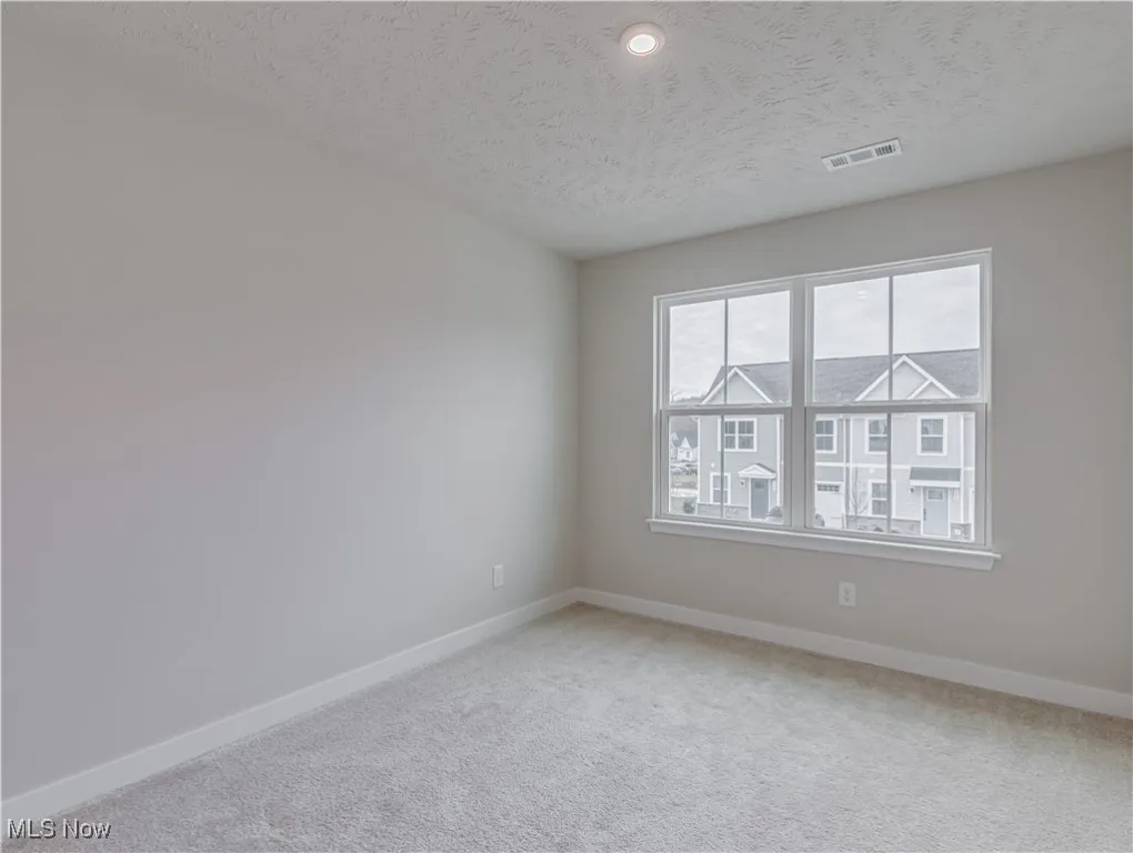 Second floor bedroom with carpet flooring