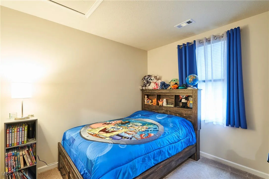 Bedroom featuring carpet and multiple windows