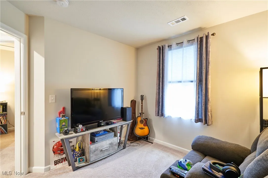 Carpeted living room with baseboards