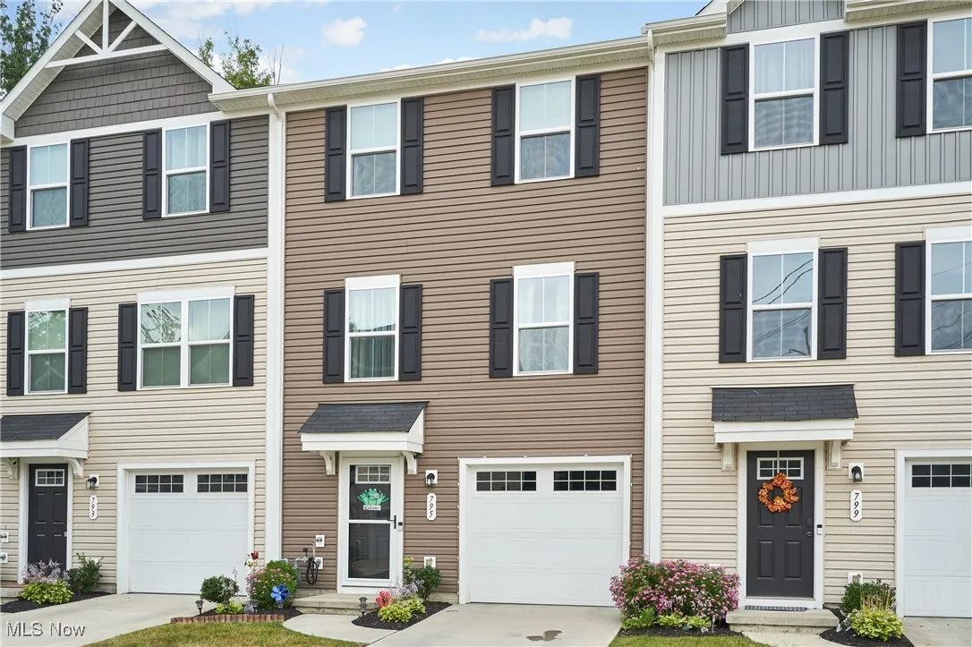 Colonial inspired home featuring an attached garage and driveway