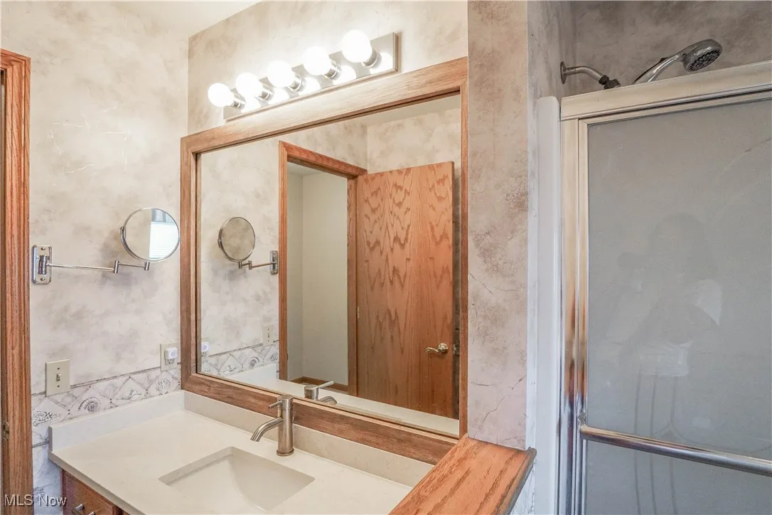 Bathroom with vanity and a shower