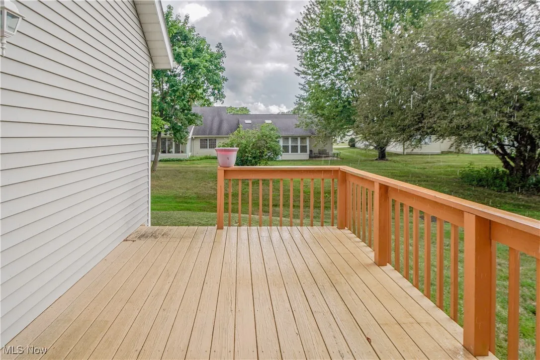 Wooden deck featuring a lawn
