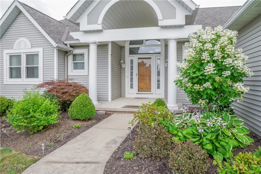 Doorway to property featuring a covered front porch