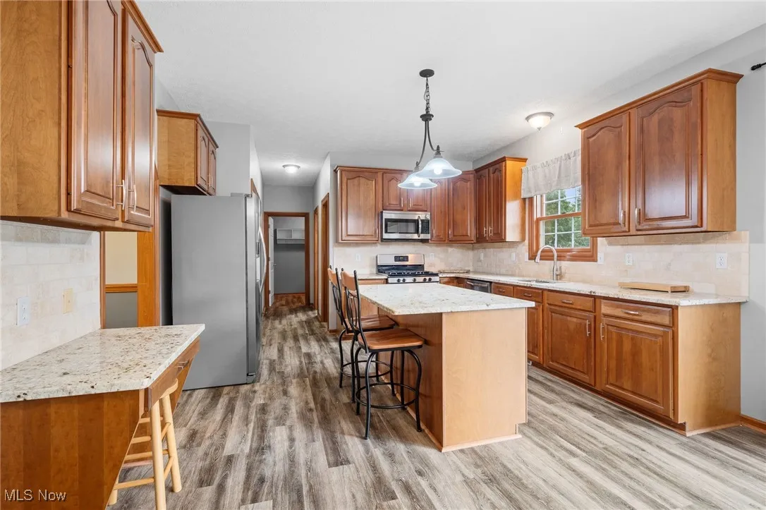 Eat-in kitchen with 5x3ft center island/bar, granite countertops, stainless steel appliances w/gas stove and spacious pantry.