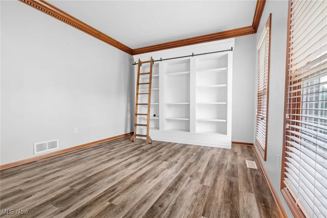 Living room or office w/LVT flooring and built-ins