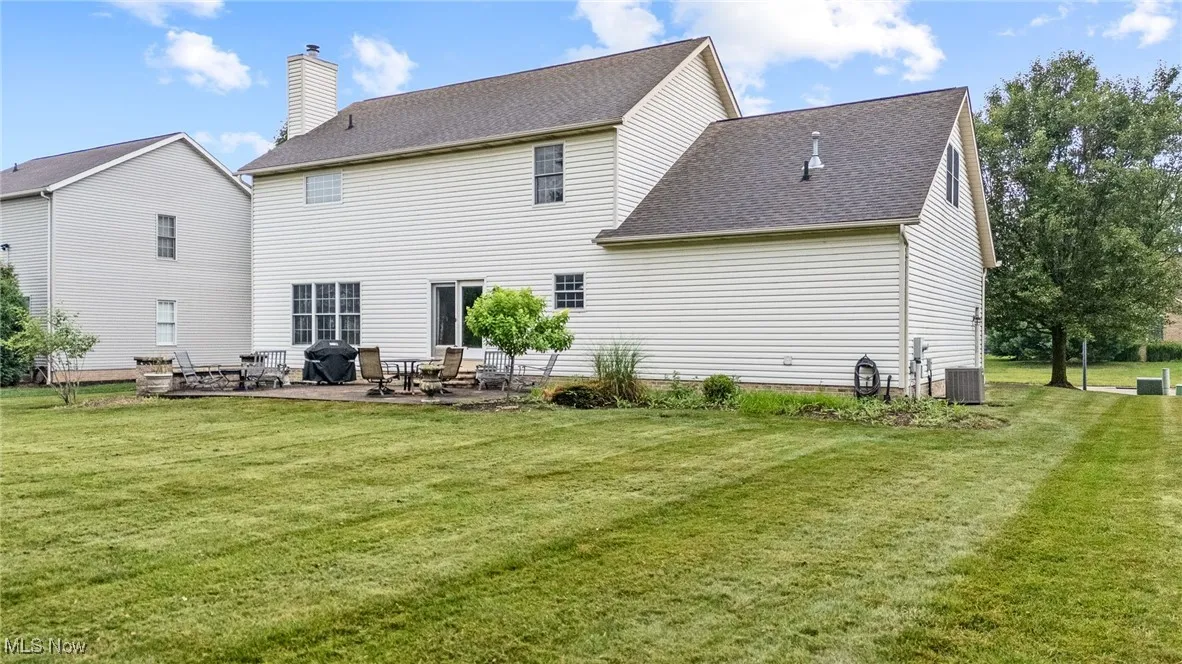 Rear view of property with lovely backyard
