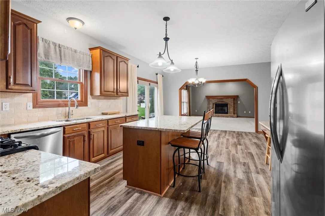 Eat-in kitchen is open to the family room w/electric fireplace