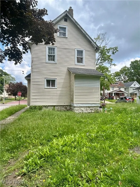 View of side of property featuring a chimney