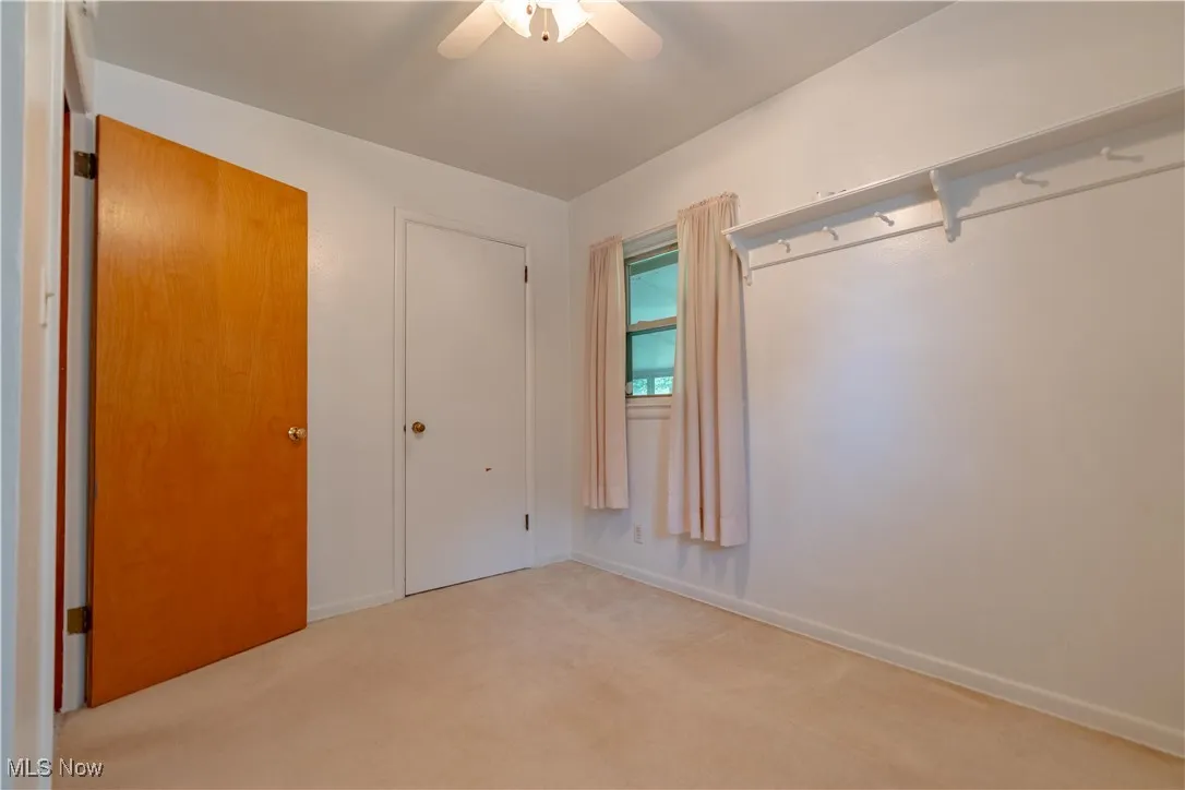 Unfurnished bedroom with carpet and ceiling fan
