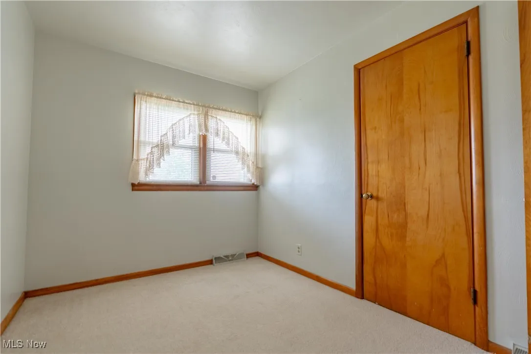 Unfurnished bedroom with carpet floors