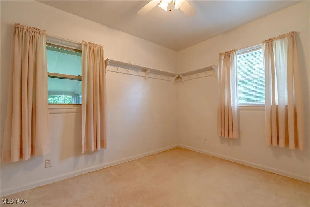 Unfurnished bedroom with carpet and ceiling fan